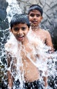 Kids enjoying and having fun with Ravana waterfall, Sri Lanka